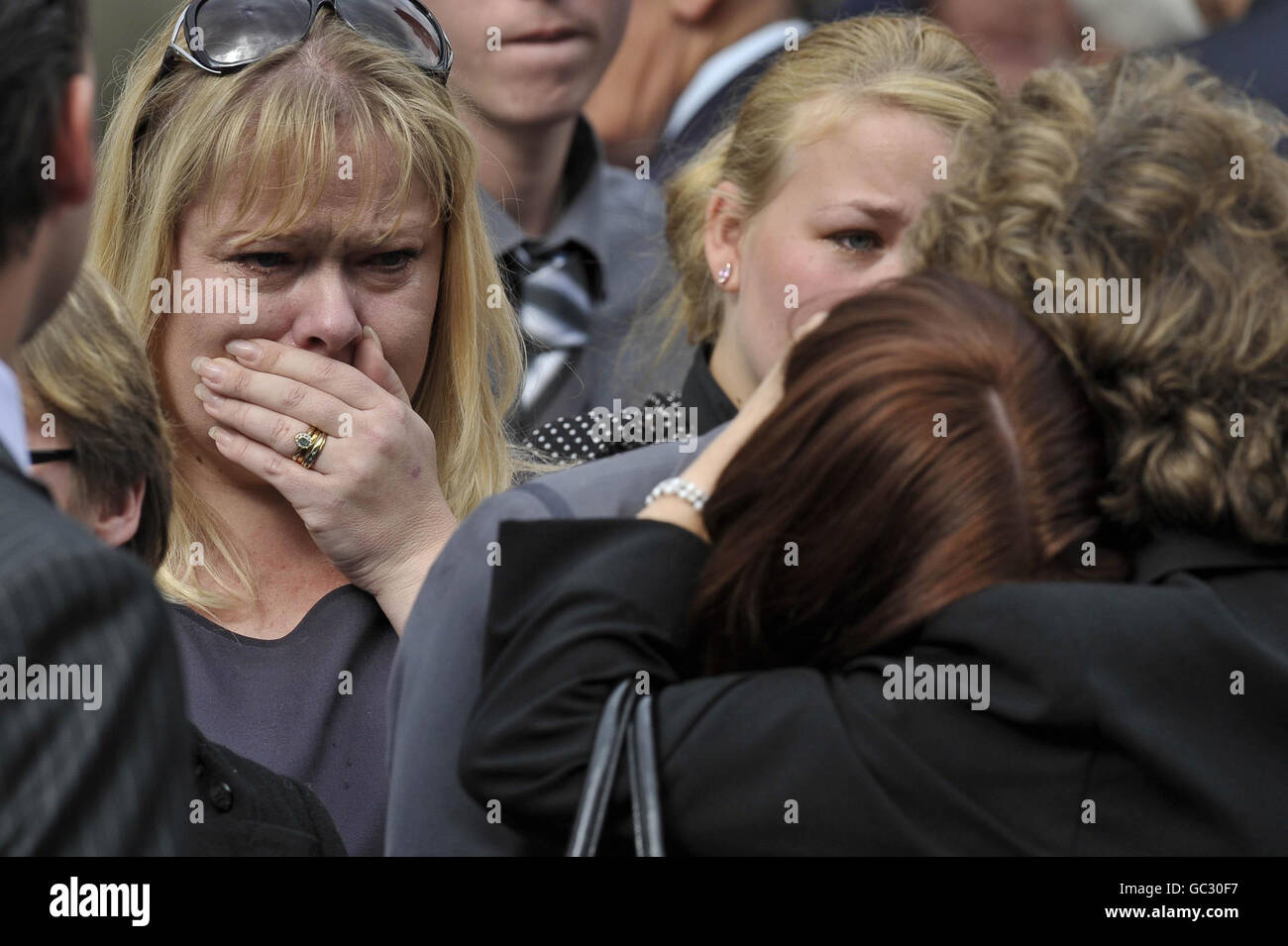 An unidentified weeps as the body of Sergent Michael Locket MC is driven through Wootton Bassett following his repatriation at RAF Lyneham, Wiltshire. Stock Photo