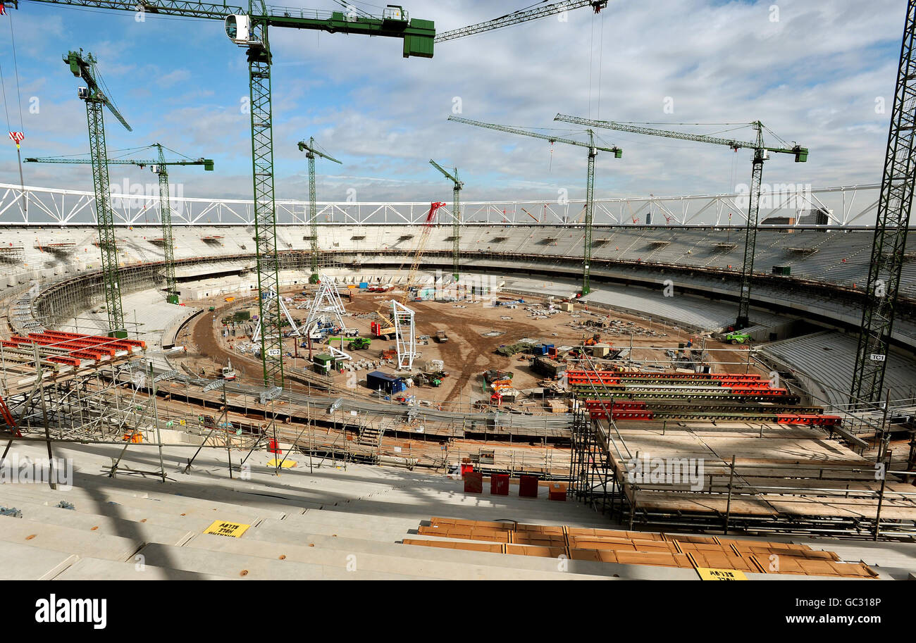 The track and field are covered in building supplies and machinery as