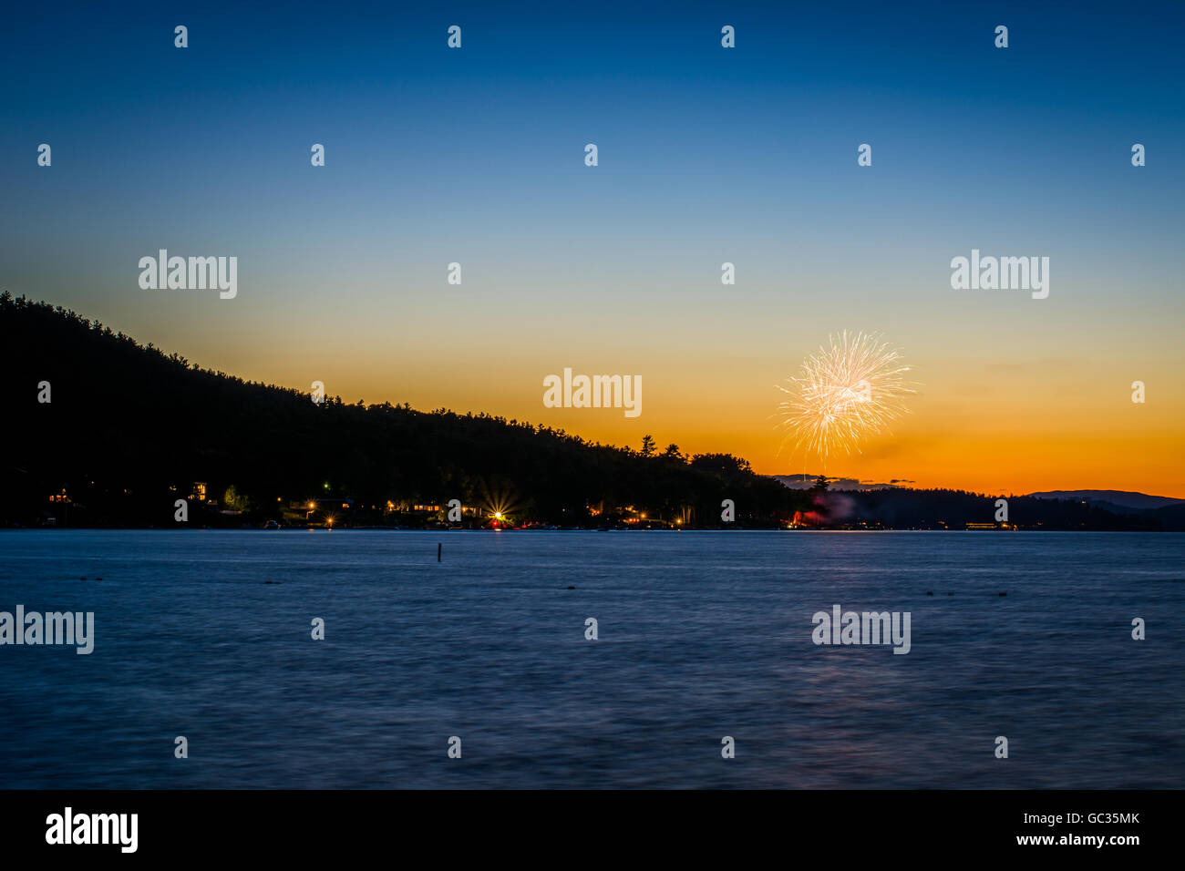 Fireworks and Lake Winnipesaukee at sunset, at Ellacoya State Park, in