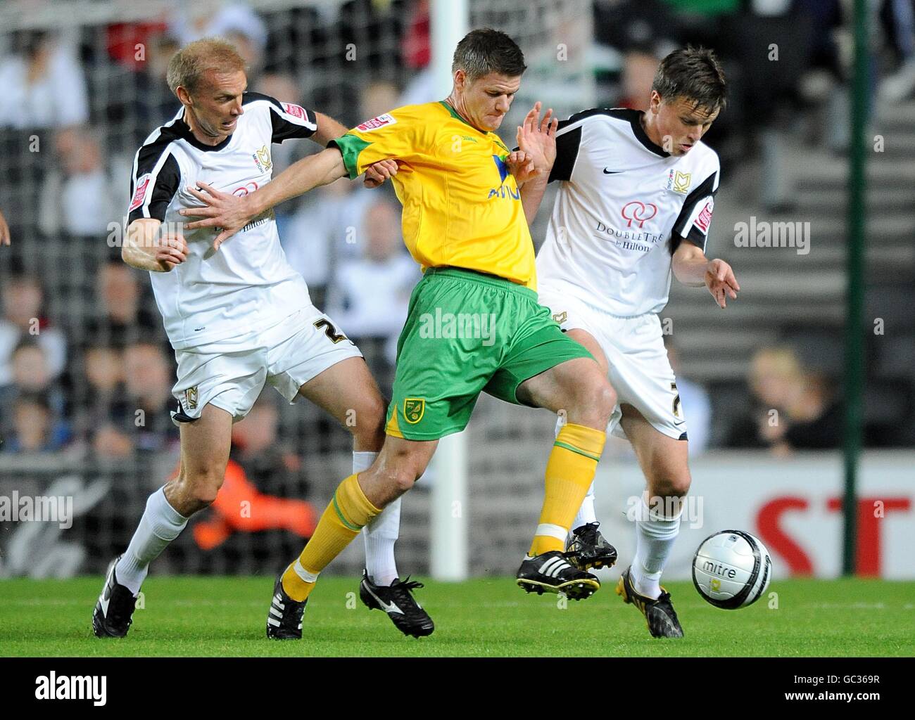 Norwich City's Michael Nelson (centre) battles for the ball with Milton Keynes Dons' Luke Chadwick (left) and Stephen Gleeson Stock Photo