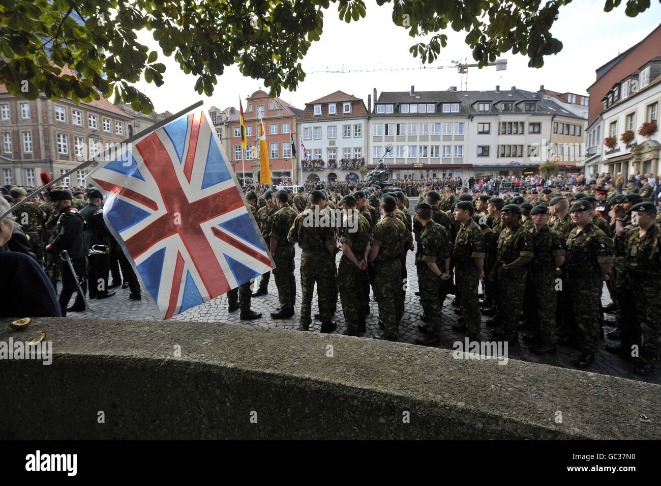 A Union flag is seen flying as over 500 soldiers from 20th Armoured Brigade - the Iron Fist, mark their return from operations in Iraq, Afghanistan and Kosovo by parading through their Garrison town of Paderborn in front of hundreds of spectators from both the local German community and soldier's families and friends. Stock Photo
