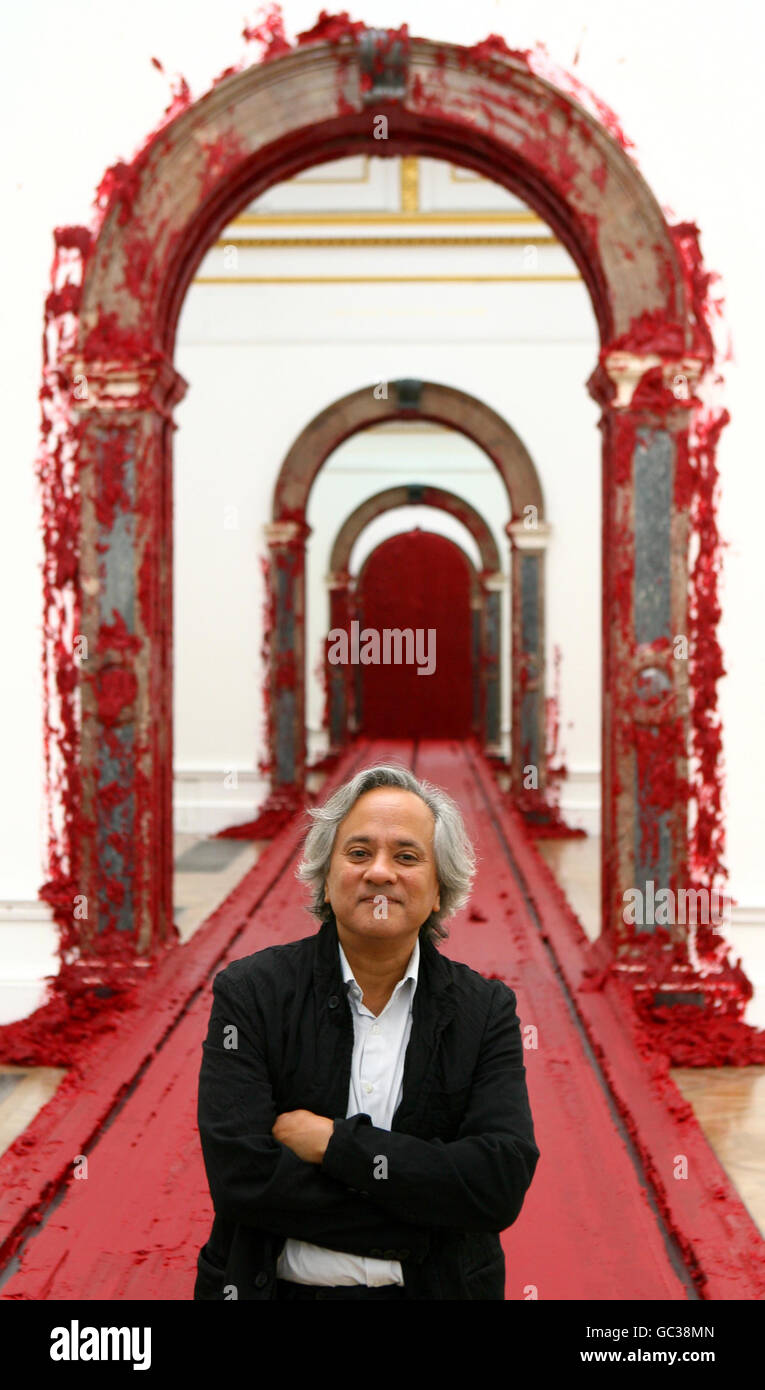 Artist Anish Kapoor stands in front of his work, Svayambh, 2007, during a press preview of a major solo exhibition of his work at the Royal Academy of Arts in central London. Stock Photo