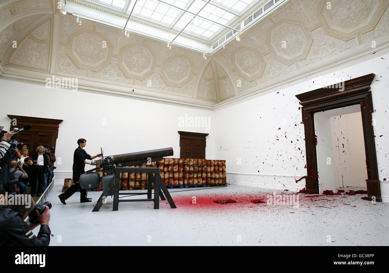 A projectile of red wax is fired into a corner by a cannon in Anish Kapoor's installation, Shooting into the Corner, 2008-09, during a press preview of a major solo exhibition of his work at the Royal Academy of Arts in central London. Stock Photo