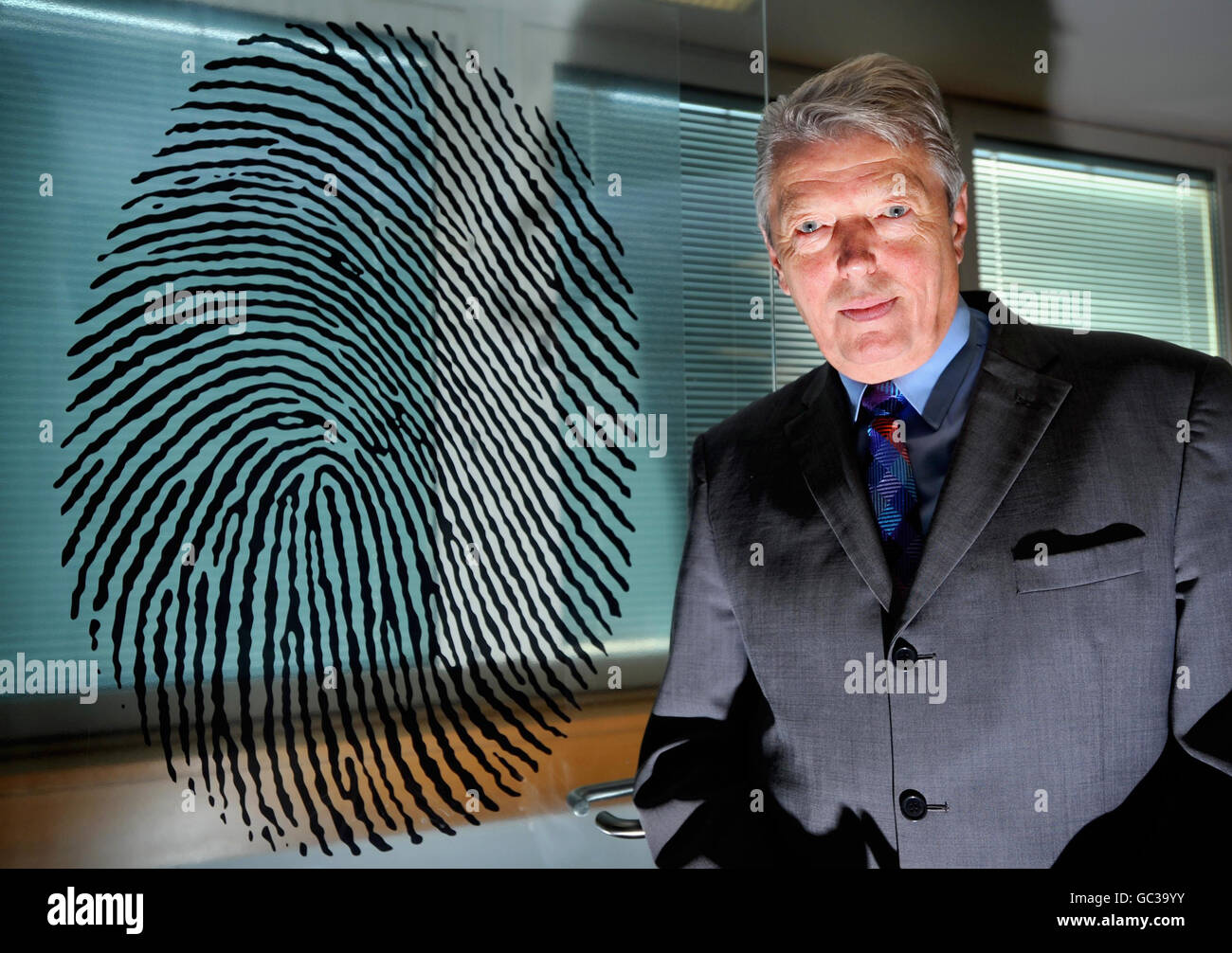 Home Secretary Alan Johnson stands at the door leading to a biometric