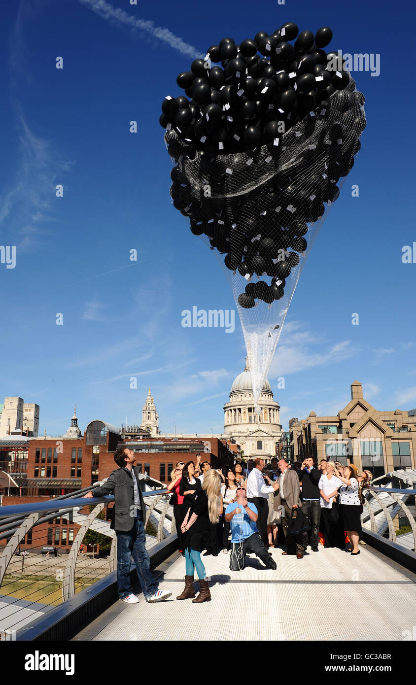 Actor Matthew Lewis (who plays Neville Longbottom) and actress Evanna Lynch (who plays Luna Lovegood), both front left, help release 1000 balloons tagged with cards, which will give the lucky recipient the chance to win a trip to the film set of the next Harry Potter film. In central London. Stock Photo