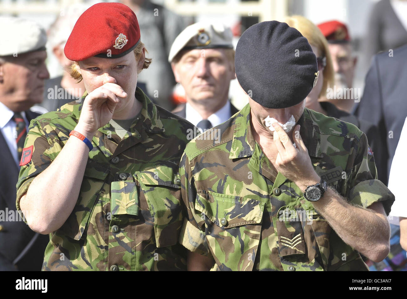 Sergeant Phil Reed weeps into a tissue as he stands beside his wife as the hearse containing his friend and fellow soldier Acting Serjeant Stuart McGrath, from 2nd Battalion The Rifles passes through Wootton Bassett. Stock Photo