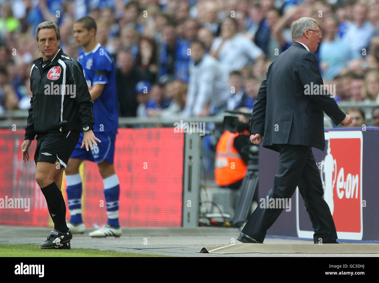 Manchester United manager Alex Ferguson (right) walks away from fourth official Alan Wiley (left) after venting his frustration Stock Photo