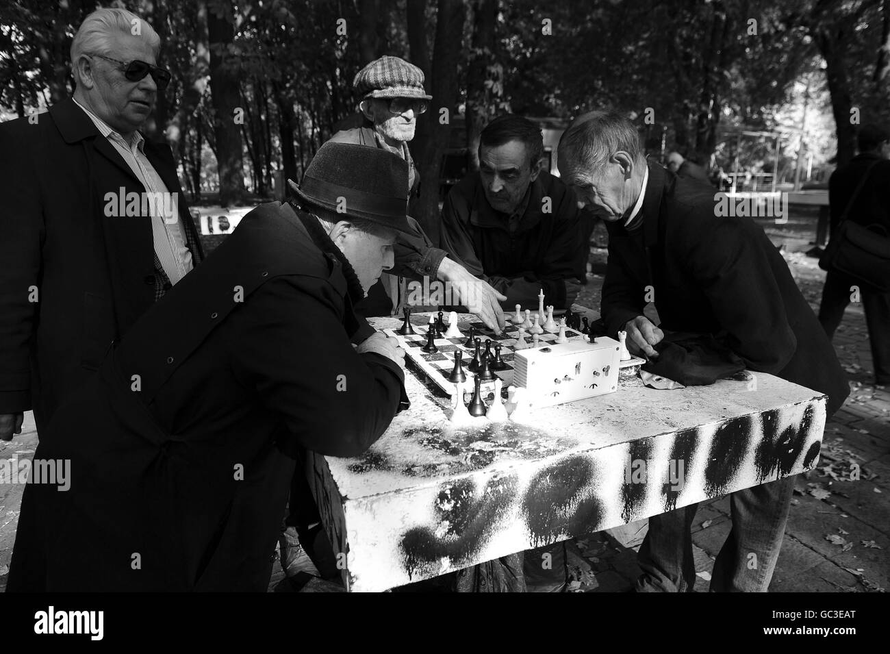 PICTURE CHANGED TO BLACK AND WHITE Men enjoy the the autumn sunshine in