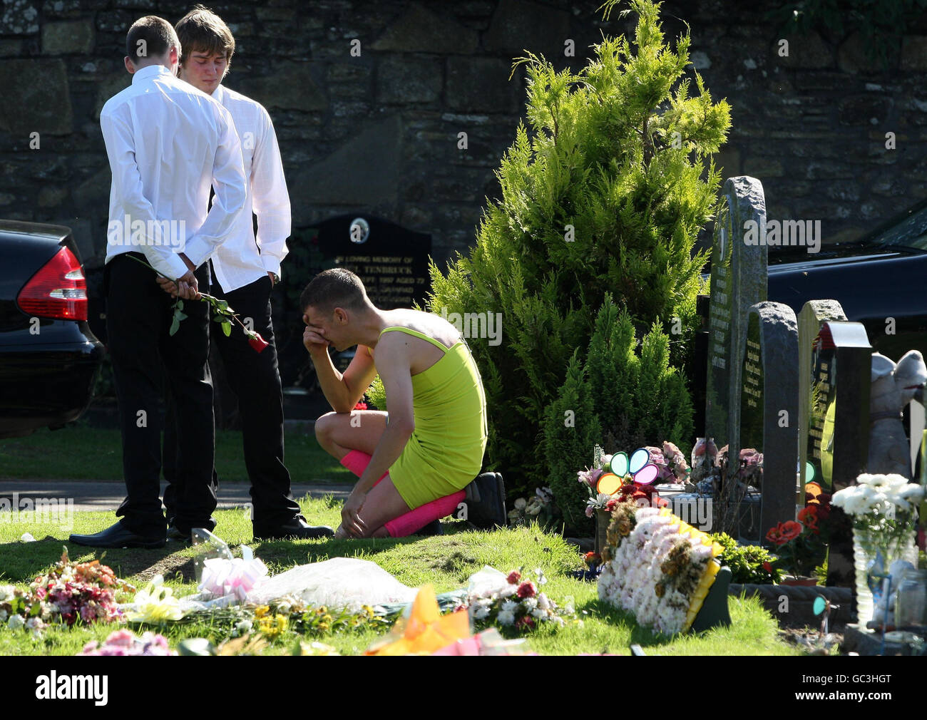 Barry delaney, wears a green dress and red socks following a bet with his  soldier friend, as the coffin of soldier private kevin elliott, 24, of the  black watch, arrives at barnhill