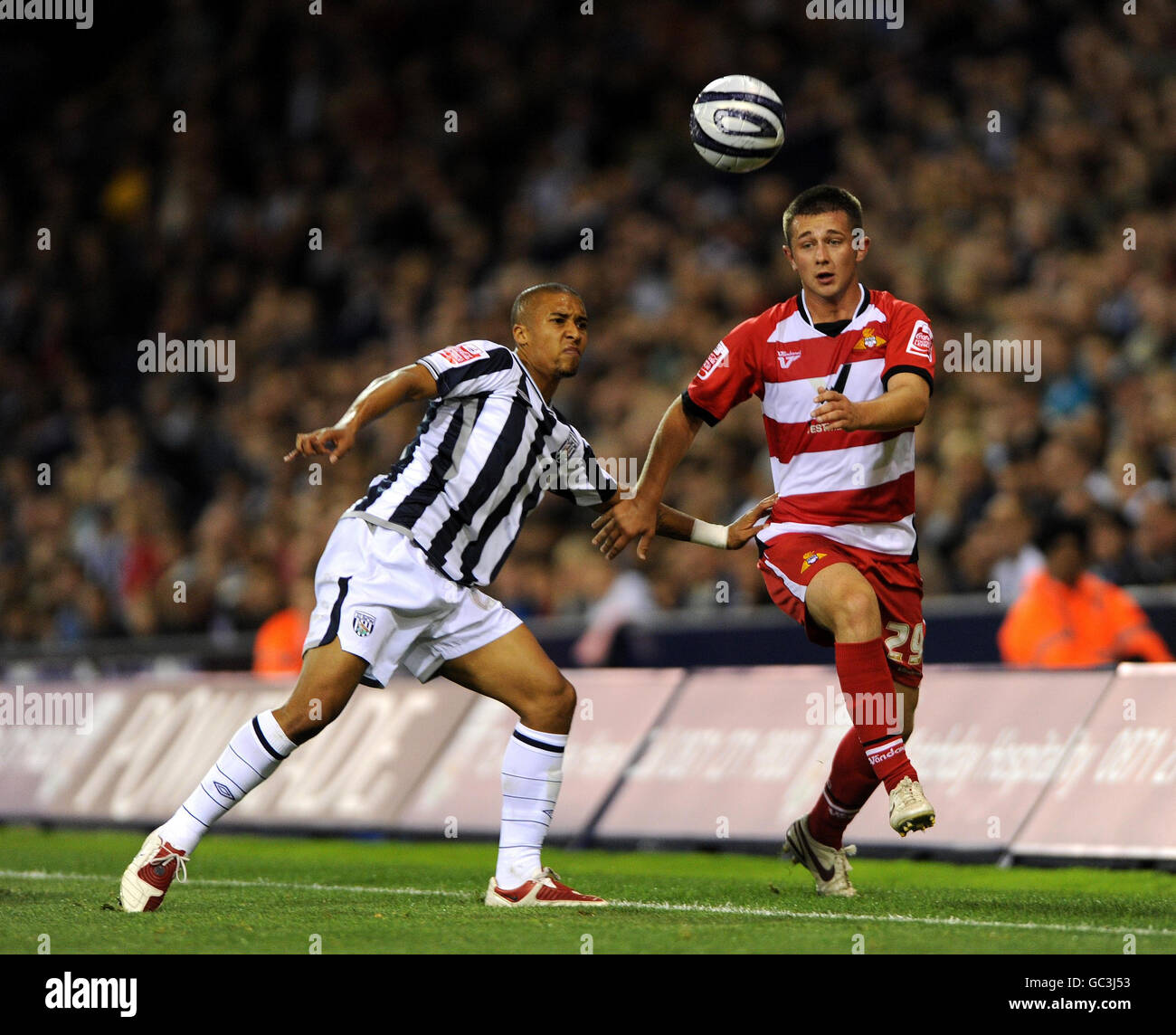 West Bromwich Albion's Gianni Zuiverloon (left) and Doncaster Rovers' Waide Fairhurst battle for the ball during a Coca-Cola Championship match at The Hawthorns, West Bromwich. Stock Photo