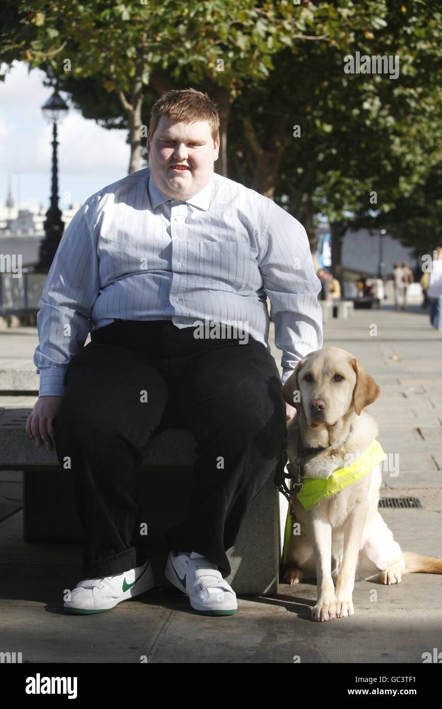 Sidney Tambin 18 from Durham with his Guide Dog Jamie, one of the first four people under sixteen to qualify for a Guide Dog in the UK who were united for the first time on London's Southbank. Press Association Photo. Date Sunday 04 October 2009. Over 18,000 blind and partially sighted youngsters are missing out on crucial help with mobility, independence and life skills according to research by Guide Dogs. Picture Credit should read David Parry/ PA Stock Photo