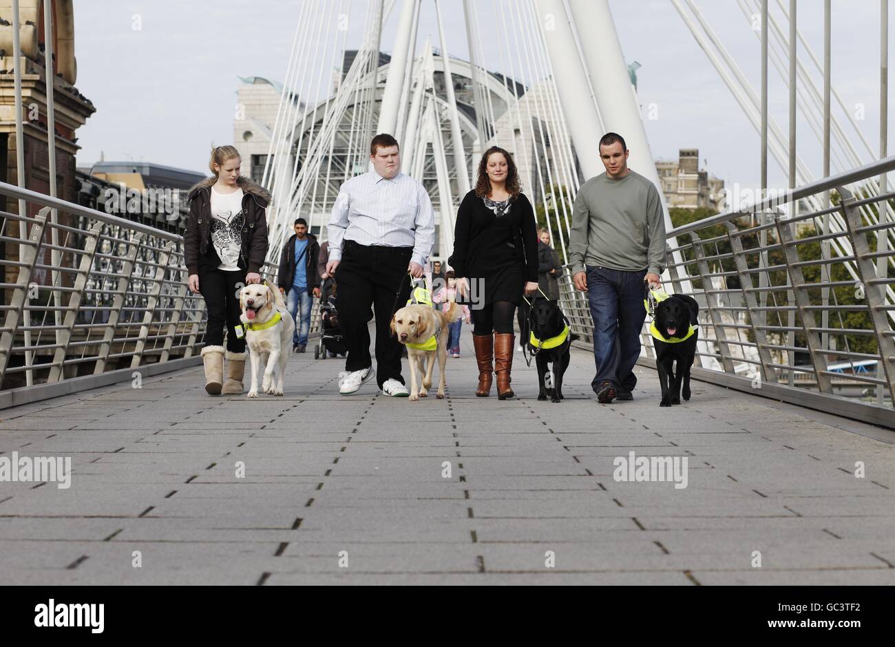The first four people under sixteen to qualify for a Guide Dog in the UK who were united for the first time on London's Southbank. L-R Kirsty Meinhardt 15 with Websta, Sidney Tamblin 18 with Jamie, Andrea Cooper 18 with Cara and Brad Ranson 16 with Lance. Press Association Photo. Date Sunday 04 October 2009. Over 18,000 blind and partially sighted youngsters are missing out on crucial help with mobility, independence and life skills according to research by Guide Dogs. Picture Credit should read David Parry/ PA Stock Photo