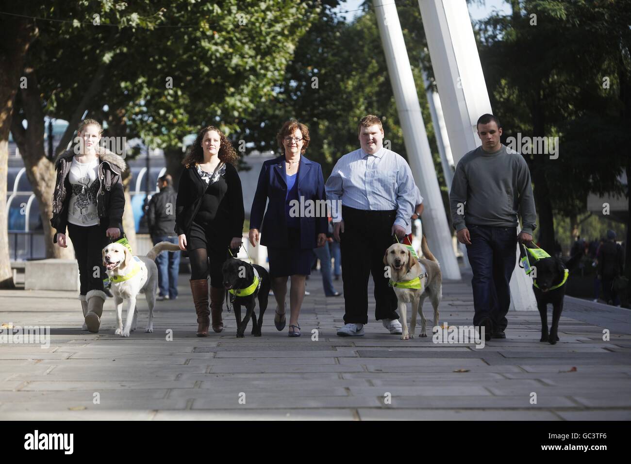 The first four people under sixteen to qualify for a Guide Dog in the UK who were united for the first time on London's Southbank. L-R Kirsty Meinhardt 15 with Websta, Andrea Cooper 18 with Cara, Bridget Warr CEO Guide Dogs, Sidney Tamblin 18 with Jamie and Brad Ranson 16 with Lance. Press Association Photo. Date Sunday 04 October 2009. Over 18,000 blind and partially sighted youngsters are missing out on crucial help with mobility, independence and life skills according to research by Guide Dogs. Picture Credit should read David Parry/ PA Stock Photo