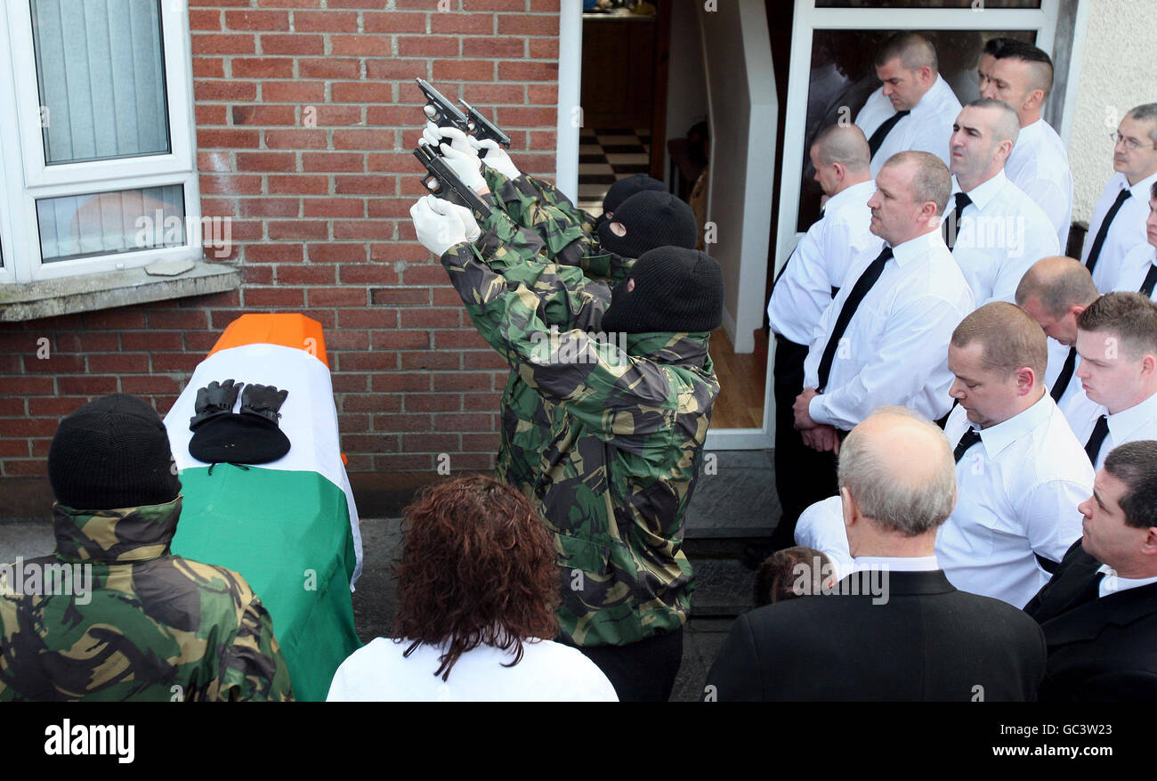 Masked gunmen fire a volley of shots over the coffin of Republican John Brady, outside his sister's home in Strabane Co Tyrone. Stock Photo