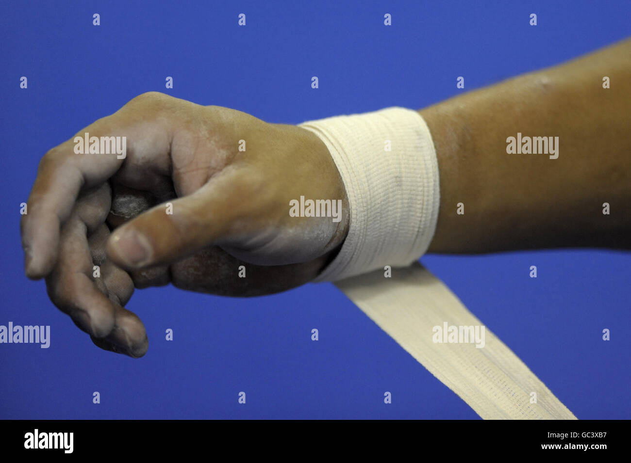 A gymnast wraps tape around his wrist during the Gymnastics World