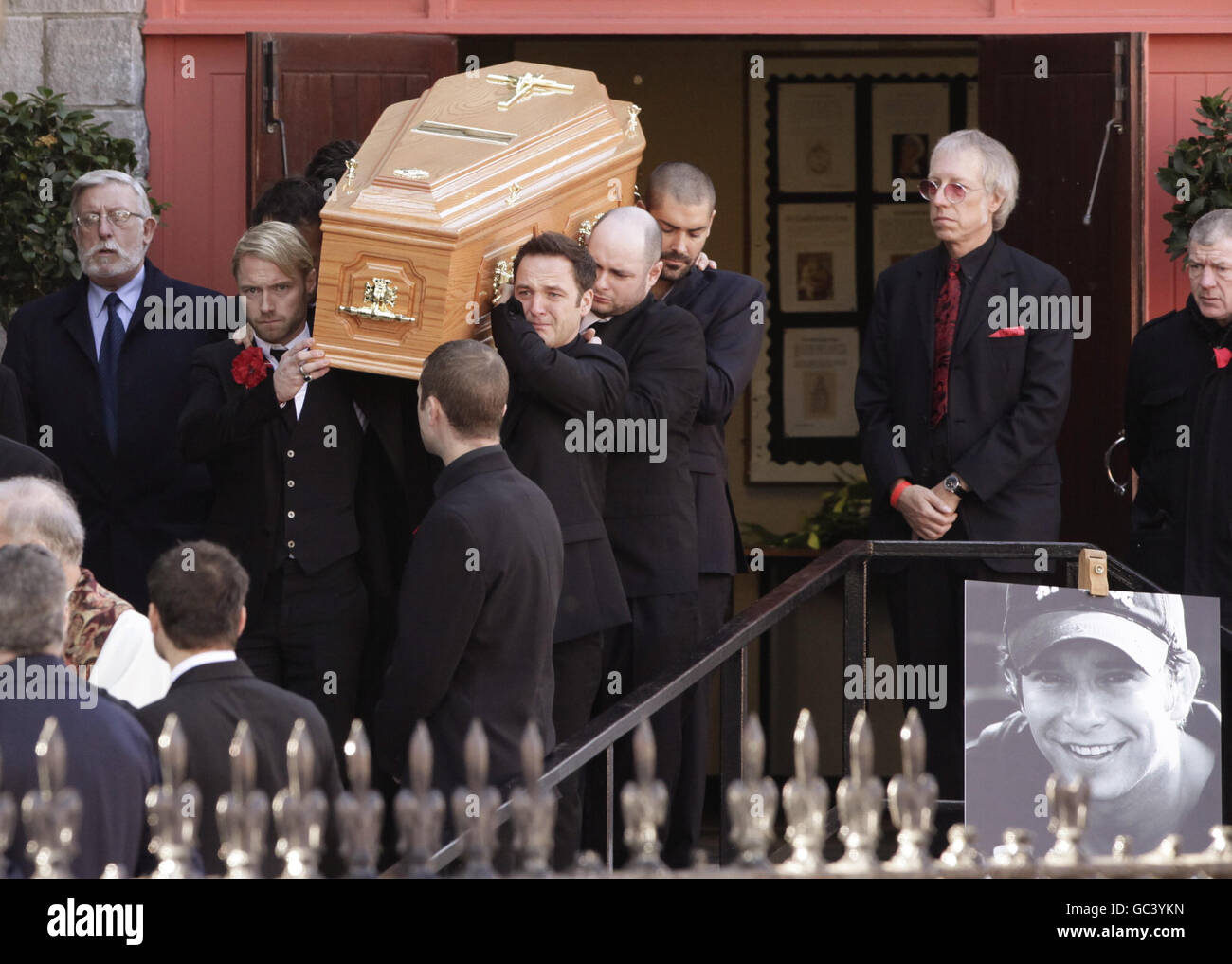 The coffin is carried out after the funeral of Stephen Gately by members of Boyzone, including Ronan Keating (front left), Mikey Graham (front right), Shane Lynch (rear right) St Laurence O'Toole Church in Dublin. Stock Photo