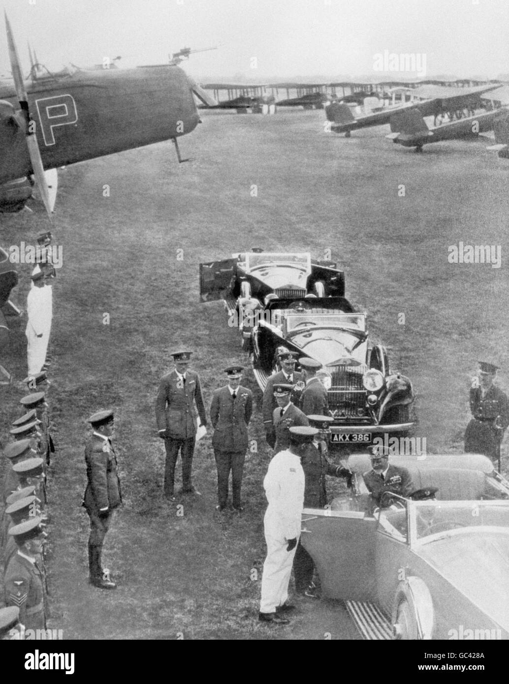 King George V, seated in car, arriving at RAF Mildenhall to review 38 squadrons of the Royal Air Force on the occasion of the royal Silver Jubilee. He was accompanied by the Prince of Wales. Stock Photo
