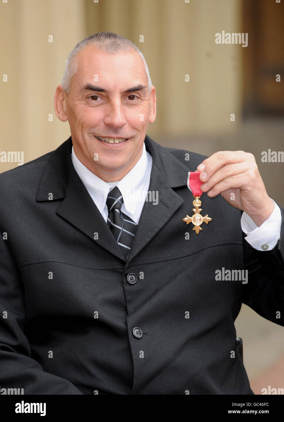 Peter Norfolk after he received his Order of the British Empire medal (OBE) for services to disabled sport, from Queen Elizabeth II at an Investiture ceremony at Buckingham Place, London. Stock Photo