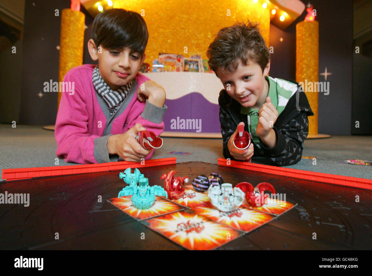 Nivi Babraa (left) and Matt Fenton both aged 10, play with the Bakugan Battle Pack from Spin Master (RRP 19.99), which has been predicted to be one of the top twelve toys this Christmas at the Toy Retailers Association's Dream Toys 2009 media preview, St Mary's Church, Marylebone, London. Stock Photo