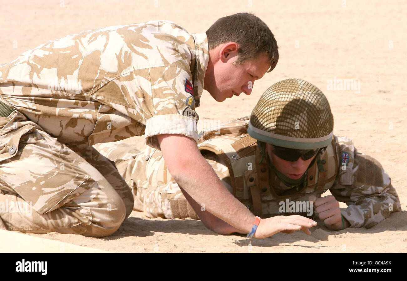 Members of the British Army on a training exercise looking for improvised explosive devices (IEDs) at Camp Bastion in Afghanistan. Stock Photo