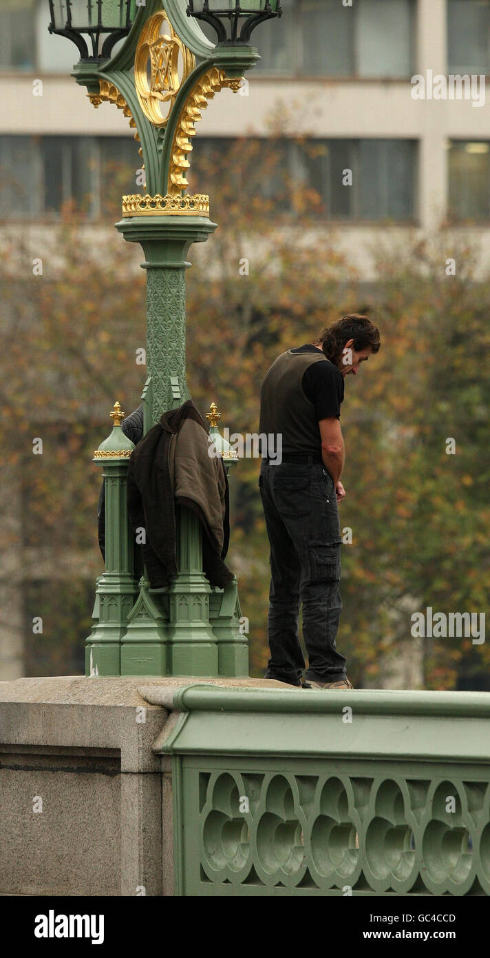 A man threatens to jump into the river Thames from Westminster Bridge in central London. Stock Photo