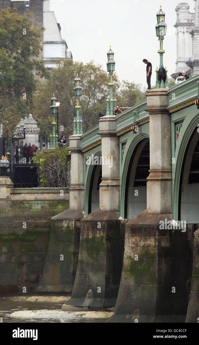 A man threatens to jump into the river Thames from Westminster Bridge, London. Stock Photo