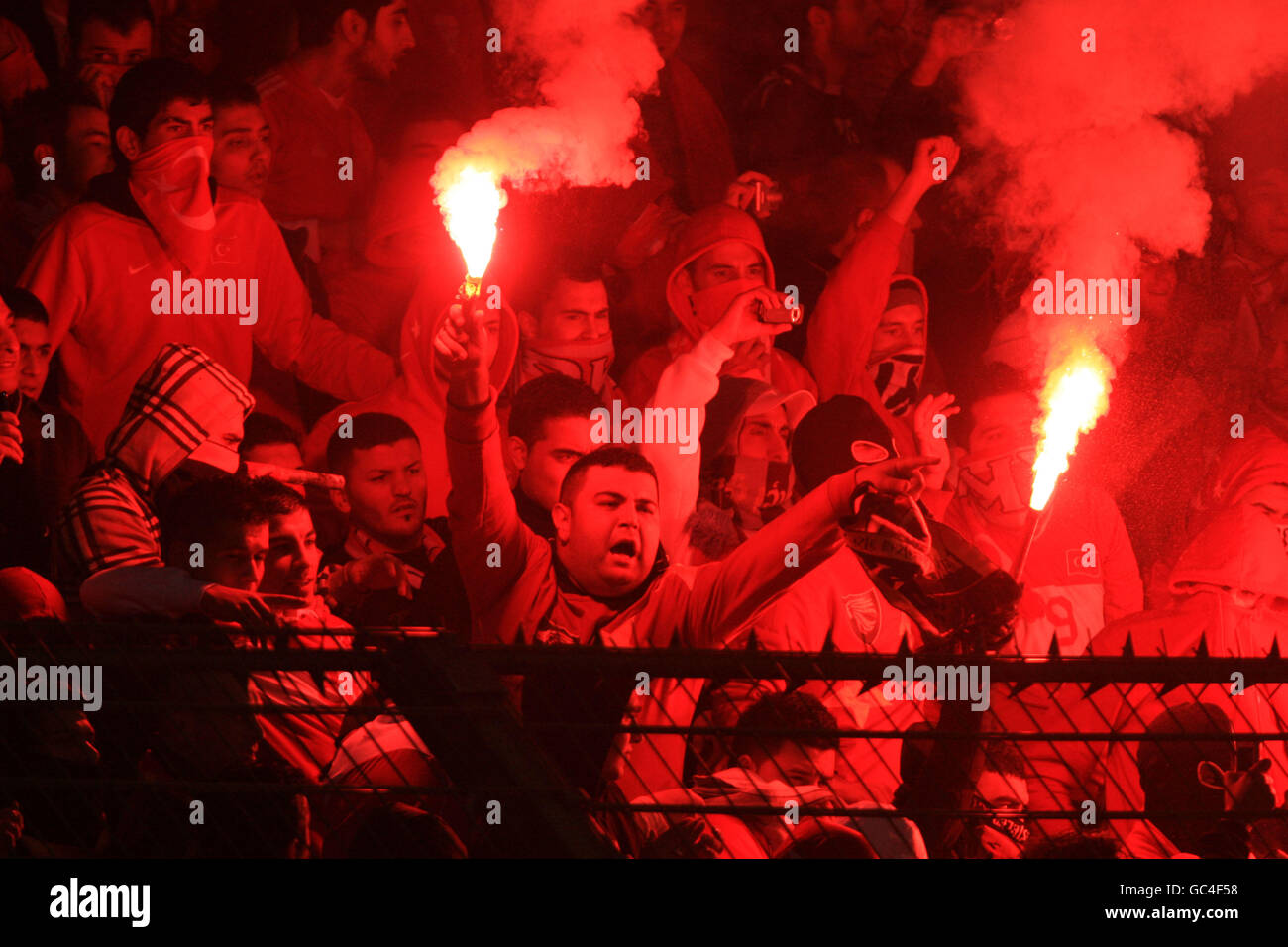 Turkish fans during the game light flares hires stock photography and