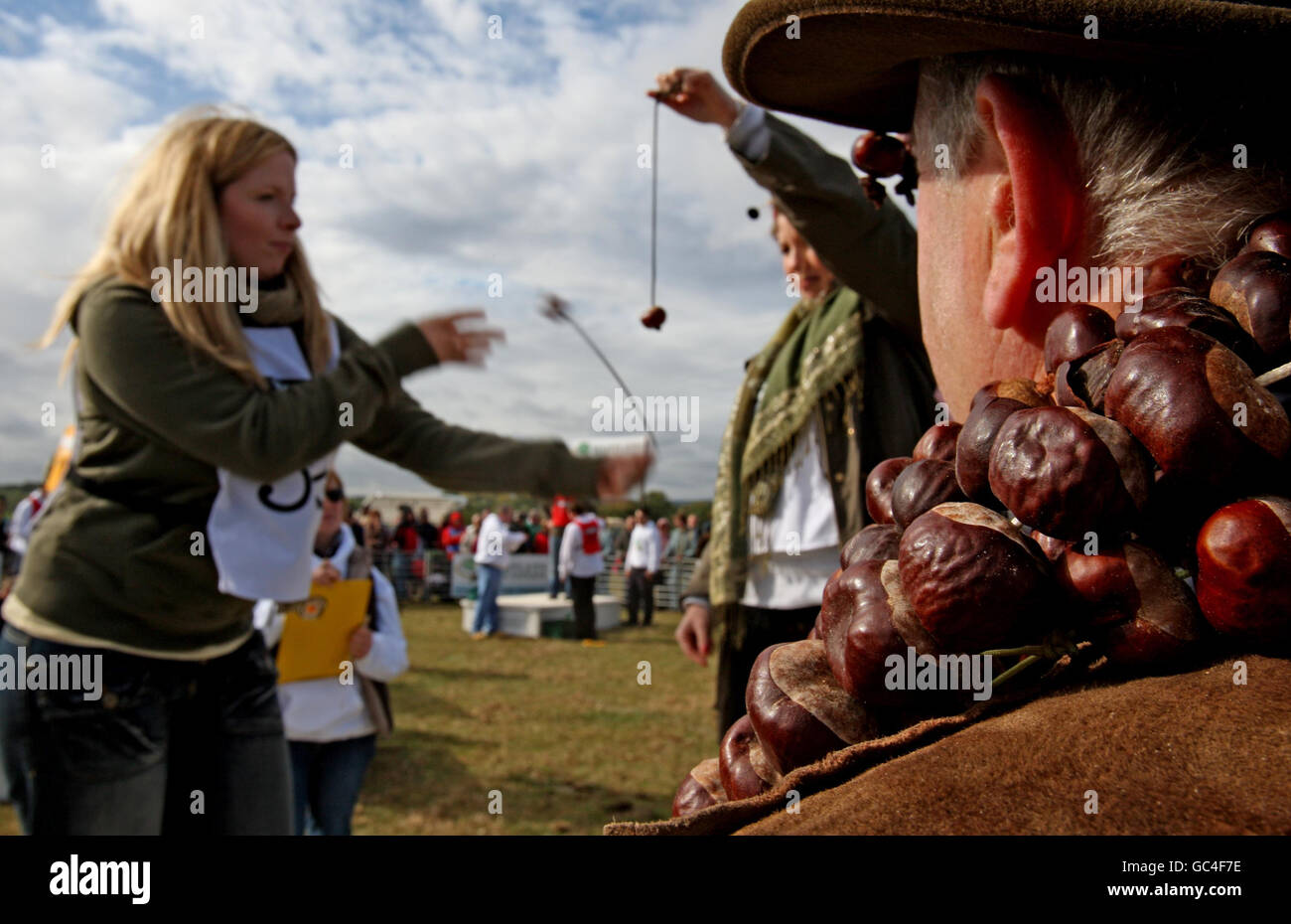 Customs and Traditions - World Conker Championships - Ashton. A competitor takes part in the World Conker Championships, at Ashton, Northamptonshire. Stock Photo