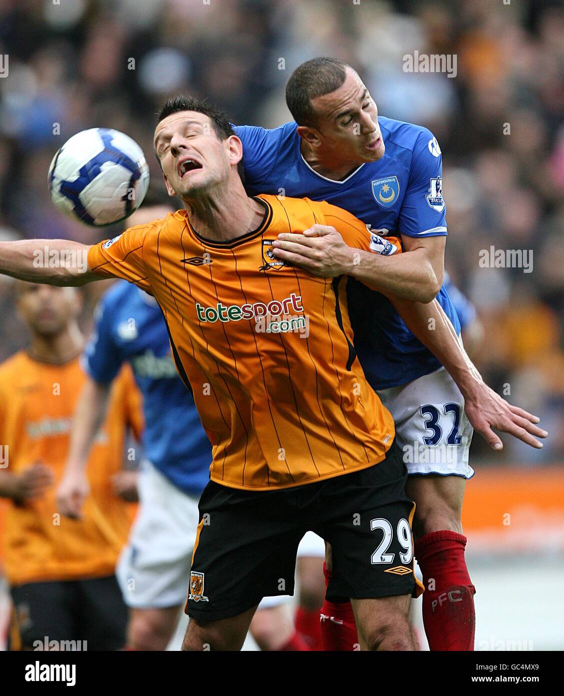 Portsmouth's Hassan Yebda (right) and Hull City's Jan Vennegoor of Hesselink (left) battle for the ball in the air Stock Photo