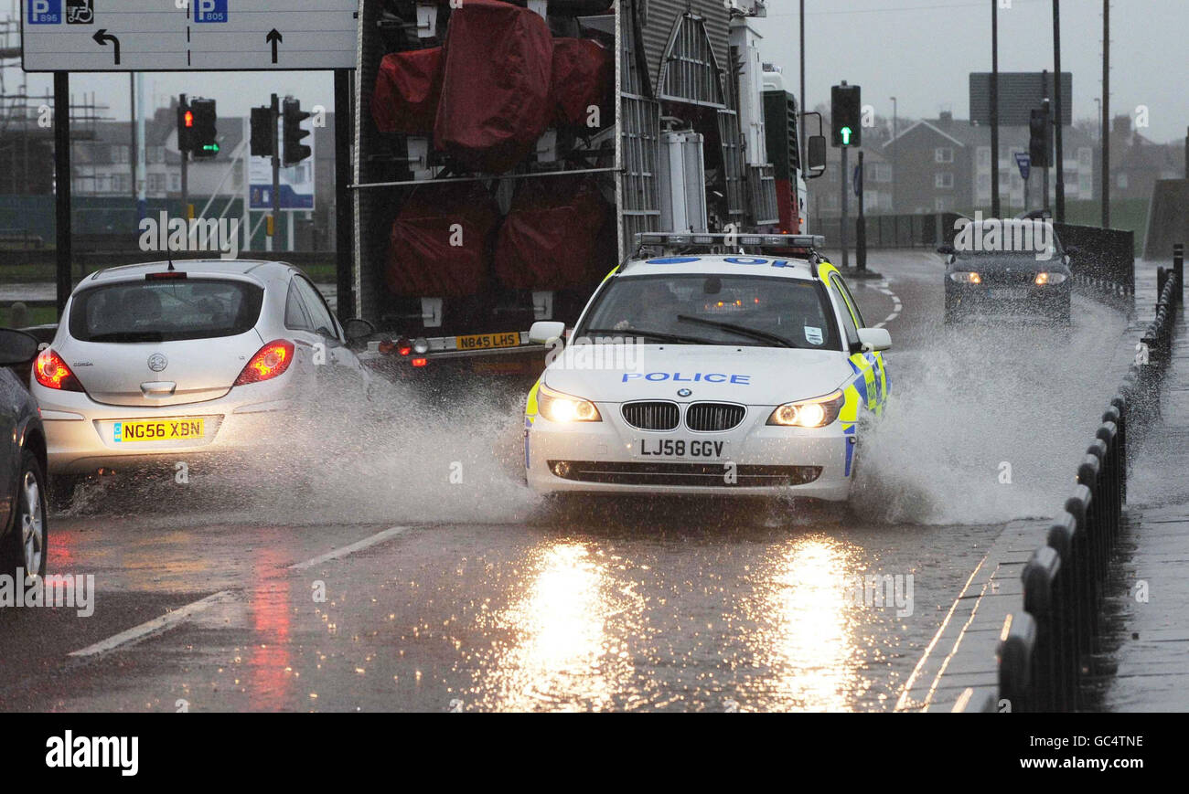 A police car drives along a flooded road in Whitley Bay, North Tyneside,Tyne and Wear as heavy downpours hit much of the UK overnight. Stock Photo