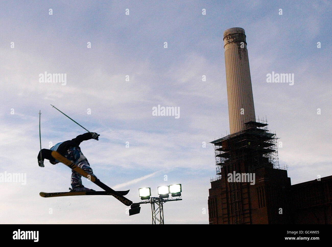 A freeskier goes past London's Battersea Power Station during their freeski practise at London Freeze weekend. Stock Photo