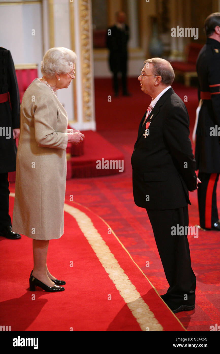 Mr. David Burgess from Swansea is made an MBE by The Queen at Buckingham Palace. Stock Photo