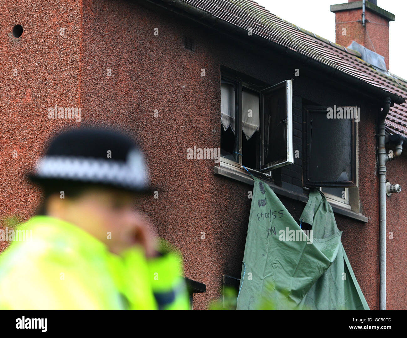 Police officers outside the house in Devondale Avenue in Blantyre after