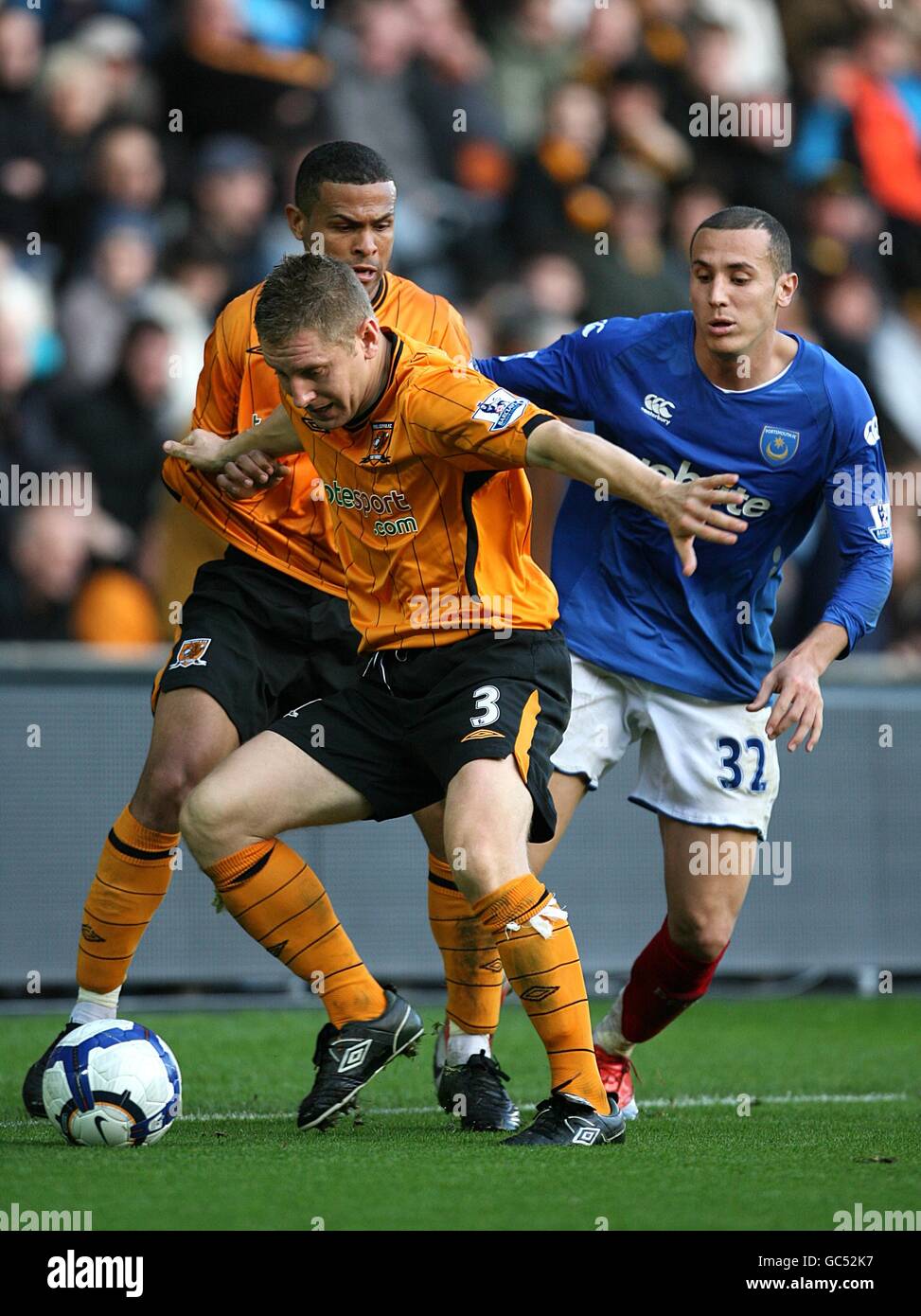 Portsmouth's Hassan Yebda (right) and Hull City's Andy Dawson (left) battle for the ball Stock Photo