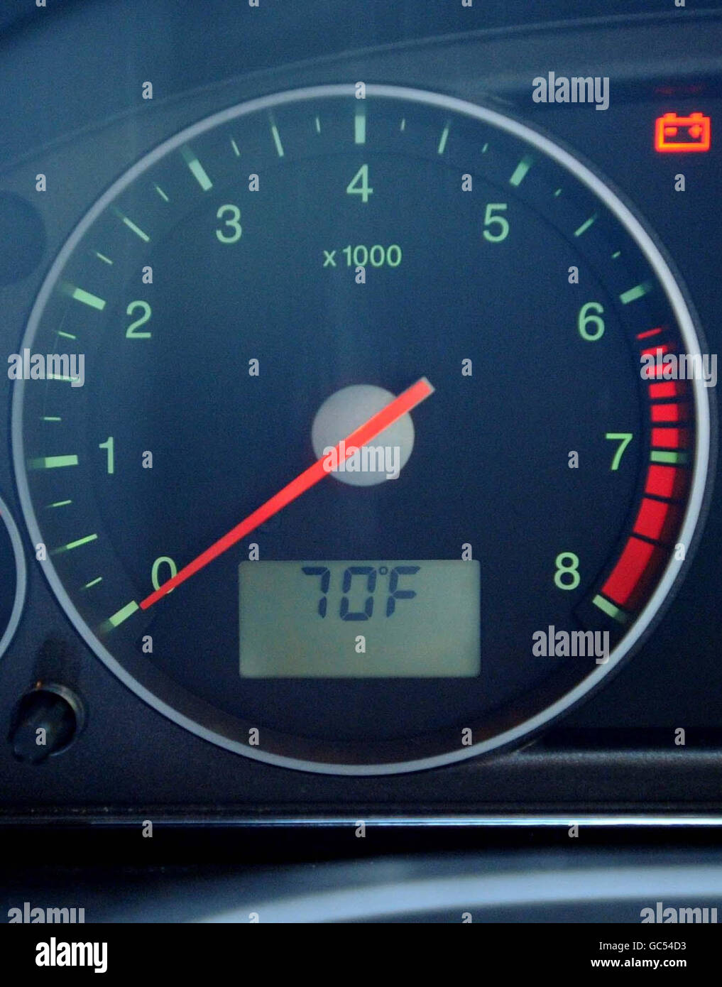 Car dashboard temperature gauge shows an outside temperature of 70F on