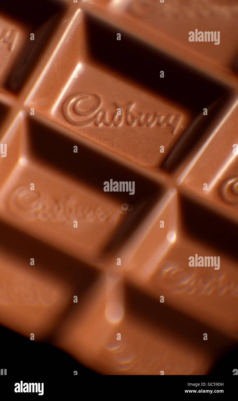 A closeup of a Cadbury logo in a bar of Dairy Milk chocolate. US food giant Kraft today launched a hostile takeover bid for Dairy Milk maker Cadbury. Stock Photo