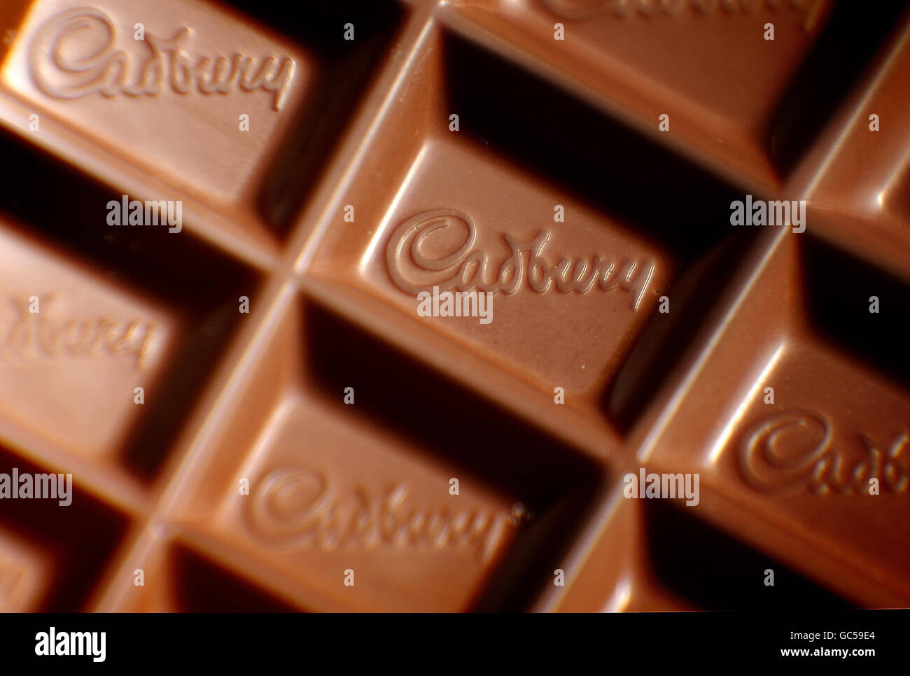 A closeup of a Cadbury logo in a bar of Dairy Milk chocolate. US food giant Kraft today launched a hostile takeover bid for Dairy Milk maker Cadbury. Stock Photo