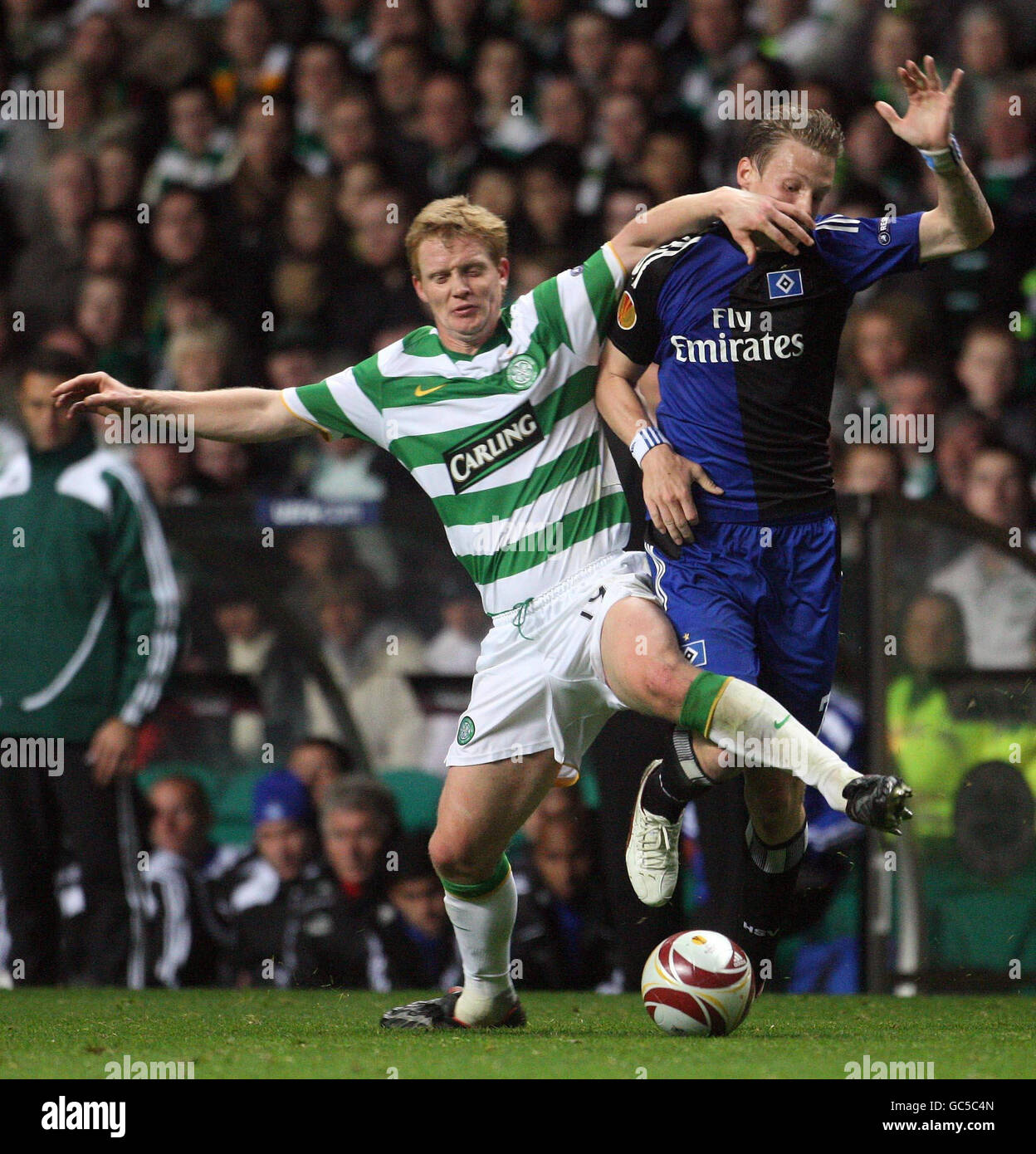 Celtic's Barry Robson and Hamburg's Marcell Jansen during the UEFA Europa League Group Match match at Celtic Park, Glasgow. Stock Photo