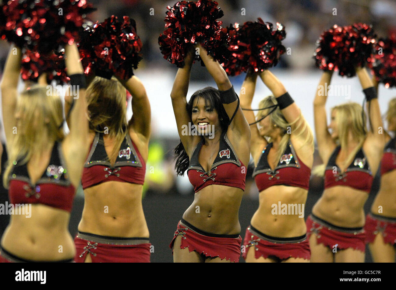 Tampa Bay Buccaneers' cheerleaders entertain the crowd before the start of the NFL match at Wembley Stadium, London. Stock Photo
