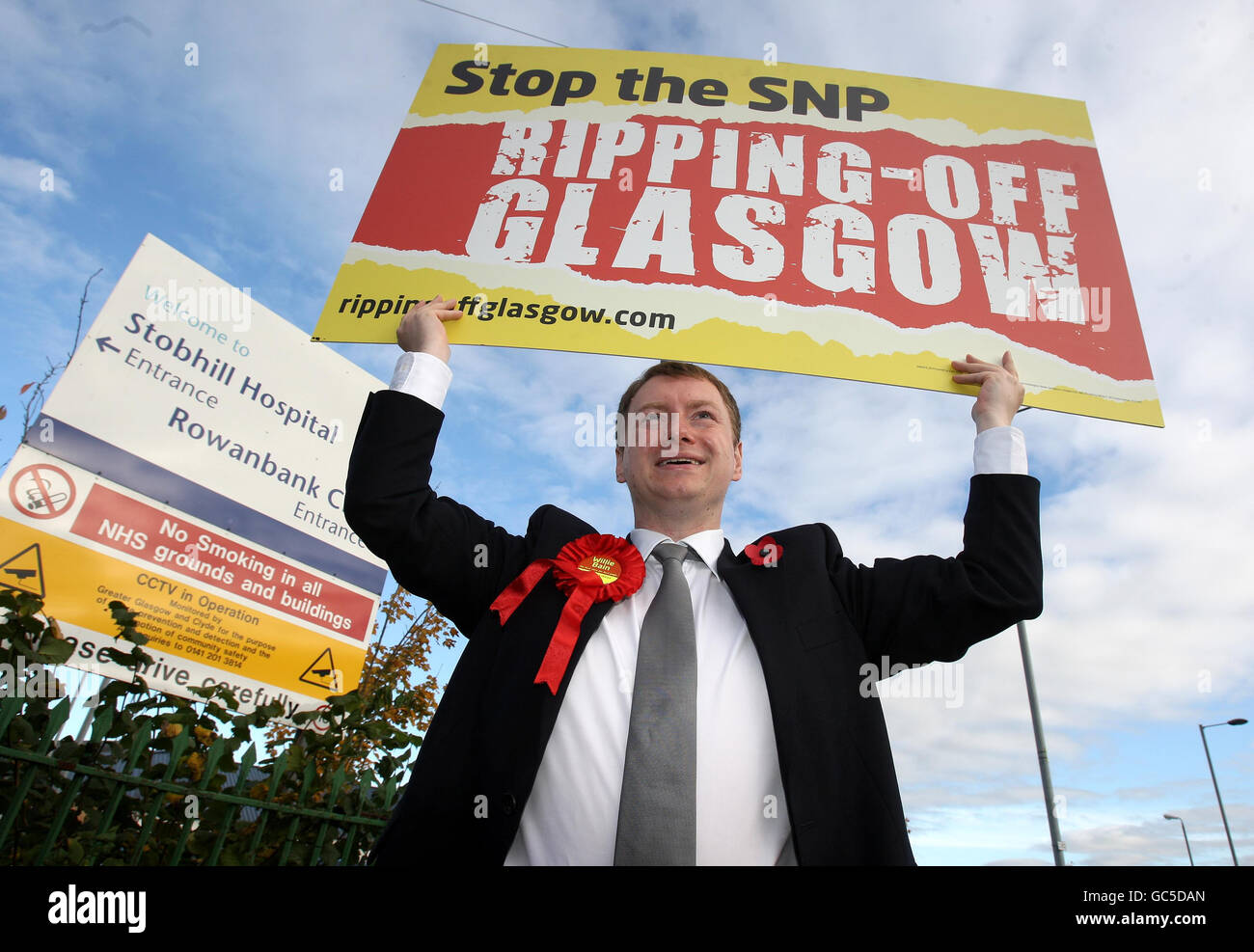 Glasgow North East by-election Labour candidate Willie Bain, holds a placard at the entrance to Stobhill Hospital in Glasgow. Stock Photo