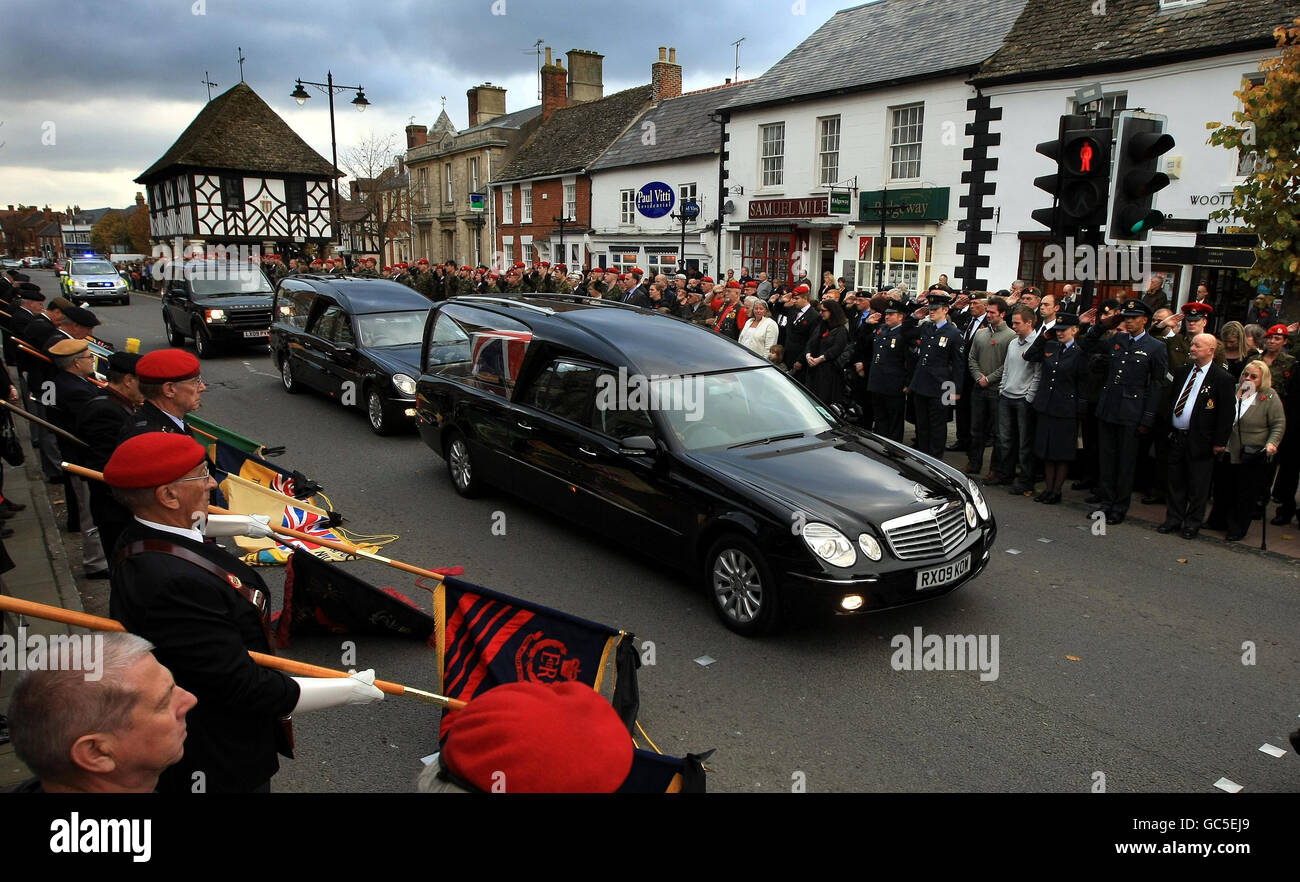 The cortege for Corporal James Oakland of the Royal Military Police pauses in the main street of Wotton Bassett following his repatriation at RAF Lyneham in Wiltshire. Stock Photo