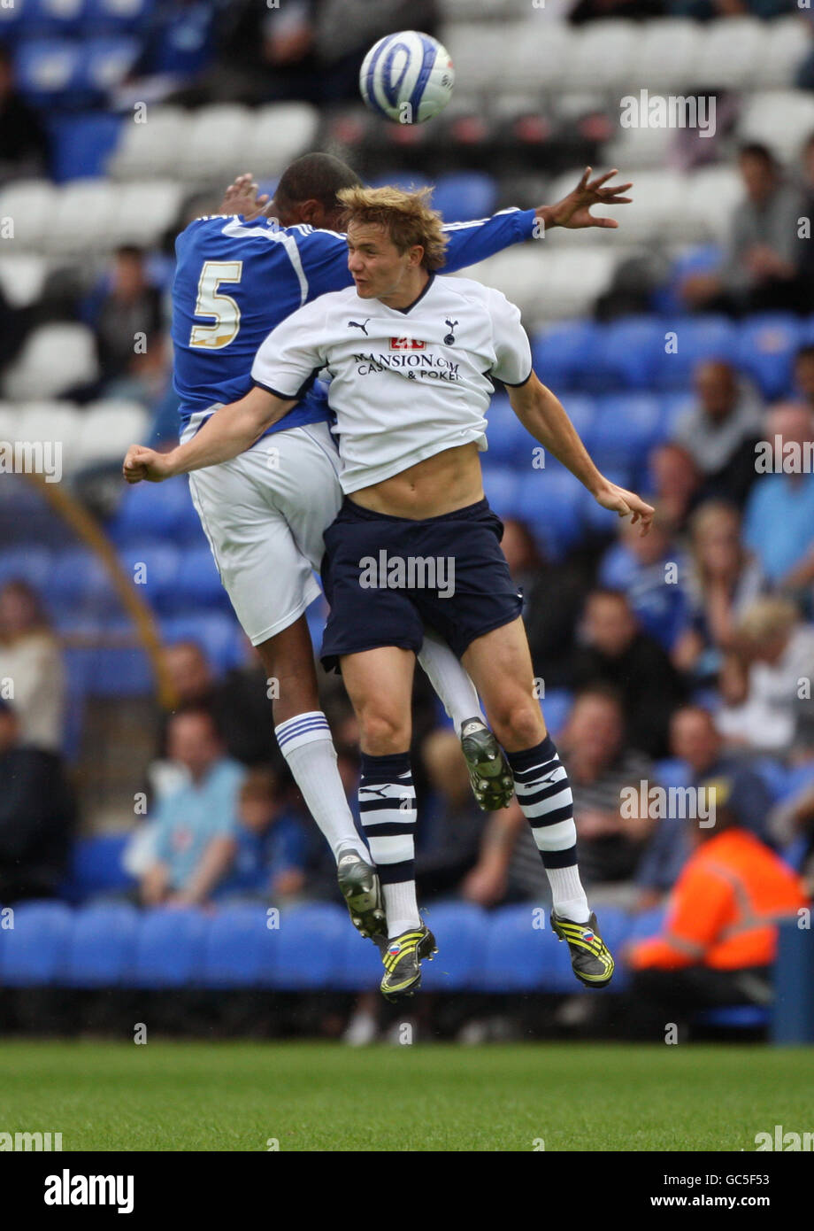 Tottenham Hotspur's Roman Pavlyuchenko (right) battles Peterborough United's Krystian Pearce (left) for the ball in the air. Stock Photo