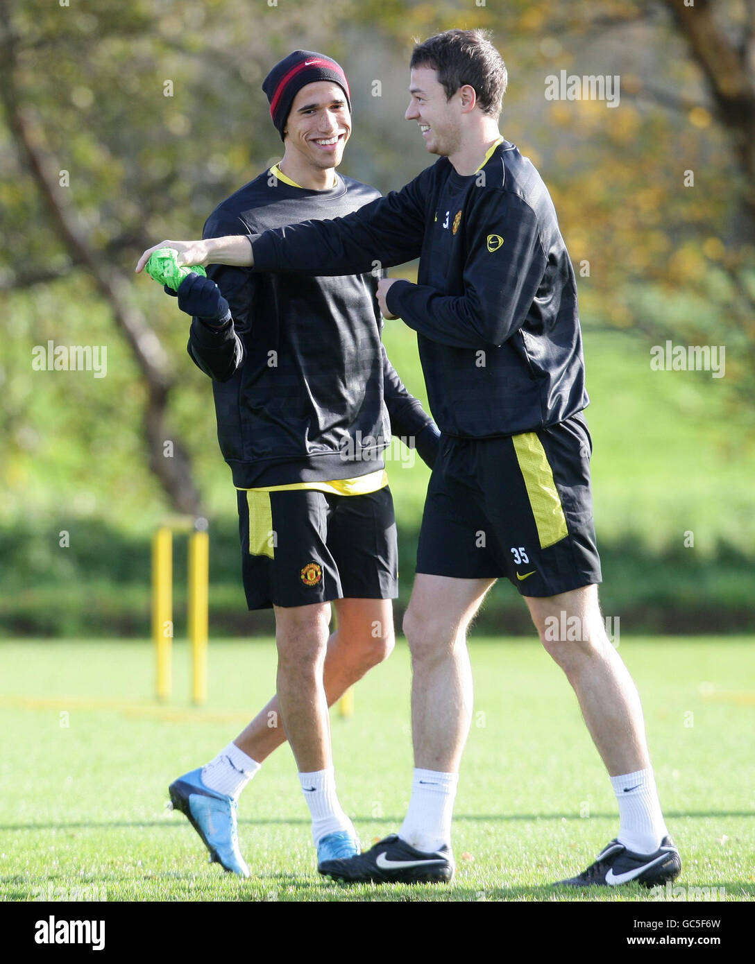 Manchester United's Gabriel Obertan (left) and Jonny Evans during a training session at Carrington Training Ground, Manchester. Stock Photo