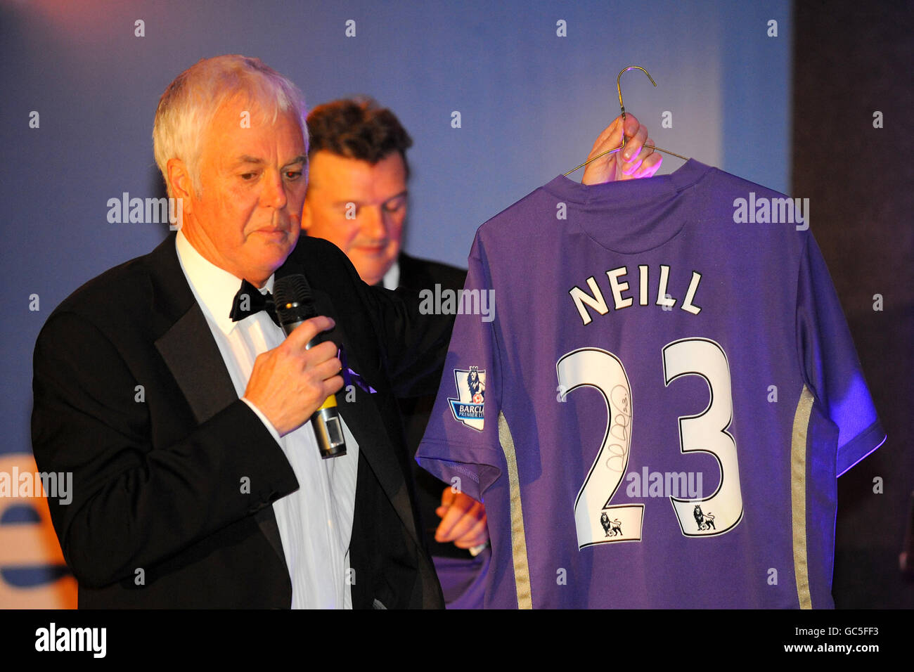 A signed limited editon purple Lucas Neill shirt is auctioned off Stock Photo