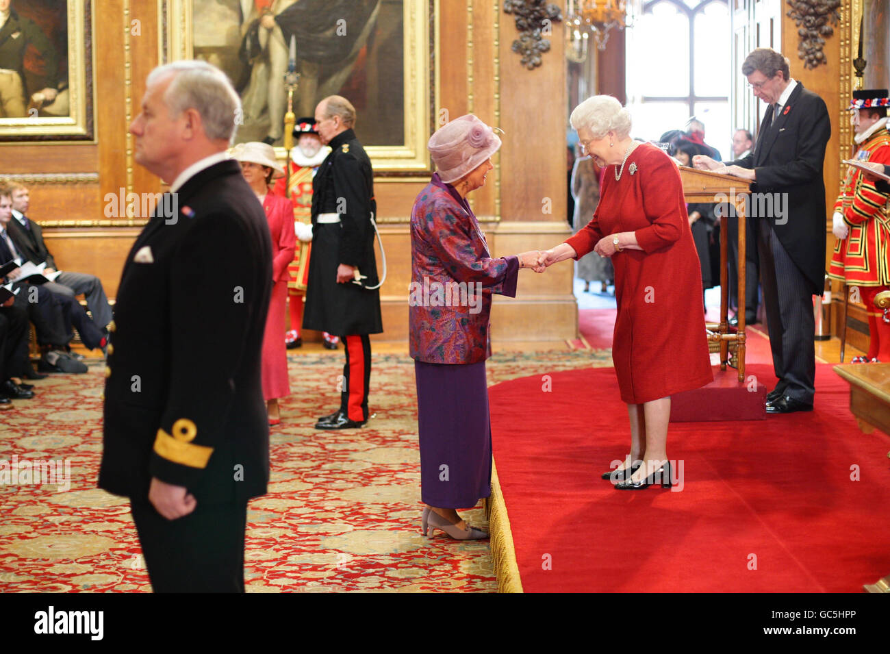 Mrs Barbara Bell from Bristol is made an MBE by Britain's Queen Elizabeth II at Windsor Castle. Stock Photo