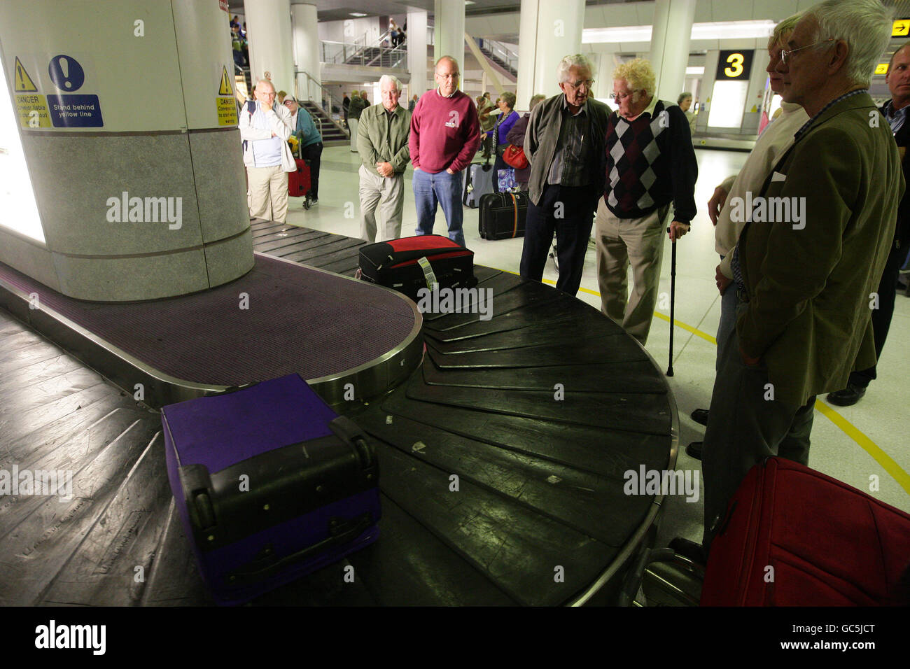 Manchester Airport stock. Passengers wait for luggage at Manchester
