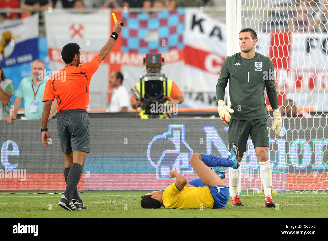 England goal keeper Ben Foster receives a yellow card for a tackle on Brazil's Honorato da Silva Nilmar (floor), and resulted in a missed penalty kick by Clemente Luis Fabiano during the International Friendly at the Khalifa International Stadium, Doha, Qatar. Stock Photo