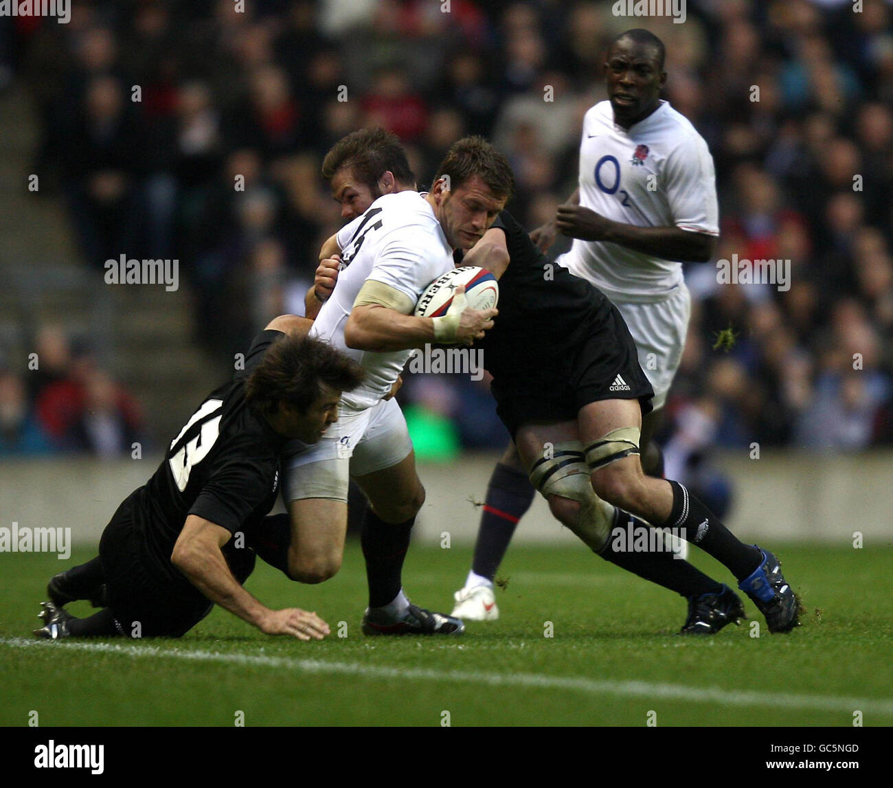 England's Mark Cueto (centre) is tackled by New Zealand's Conrad Smith (left) and Richie McCaw (right) during the Investec Challenge Series 2009 match at Twickenham, London. Stock Photo
