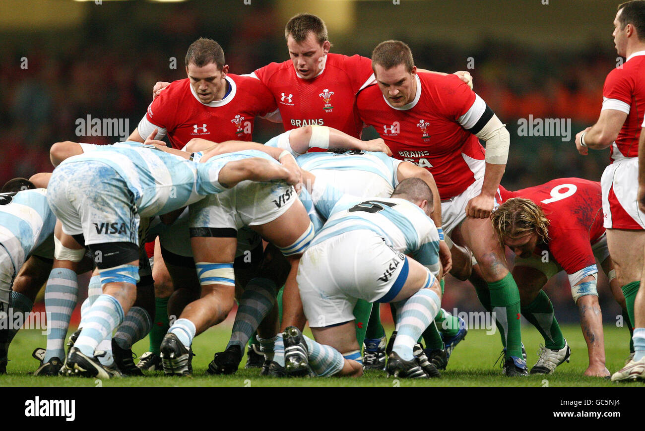Wales' front row of Paul James, Matthew Rees and Gethin Jenkins prepare to scrum down against Argentina during the Invesco Perpetual Series match at the Millennium Stadium, Cardiff. Stock Photo