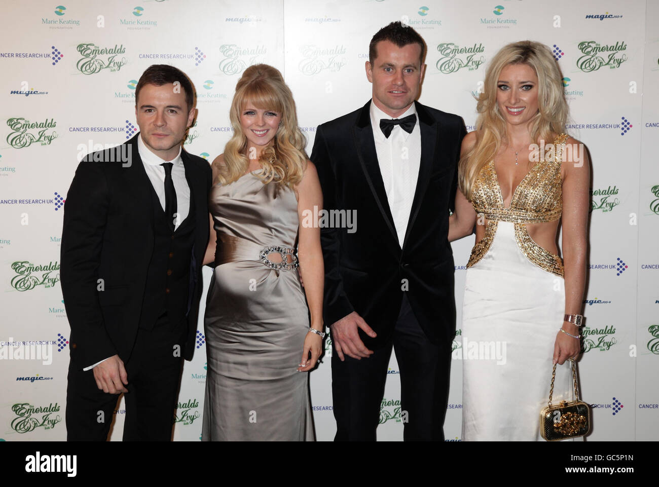 Shane Filan from Westlife (left) and his wife Gillian Walsh and goalkeeper Shay Given and his wife Jane arriving for the Emeralds and Ivy Ball - in aid of Cancer Research UK - at Battersea Evolution in south London. Stock Photo